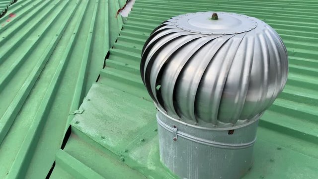 Roof wind turbine on a metal roof for air circulation