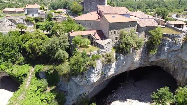 Rising and tilting aerial shot of natural bridge in Puentedey, Burgos