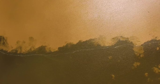 Aerial view looking down of the meeting of the waters of the Amazon River and the Tapajos River. The waters of the Amazon River are brown in color and the Tapajos River is black.