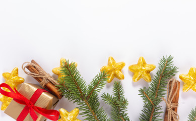 Christmas decoration on a white background with a gift, Christmas tree toys, cinnamon and Christmas tree branches. Christmas background.