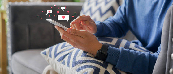 close up young man holding smartphone  while using online dating application to greeting and...