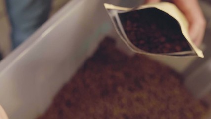 Coffee packaging A man packs coffee in a bag! High quality 4k footage