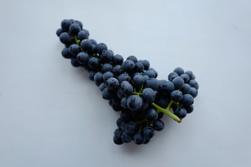 A bunch of grapes on a white background.