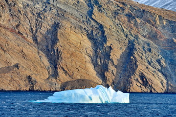 Global warming. Icebergs and mountains in the ocean.