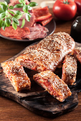 Italian stromboli stuffed with ham, salami and cheese