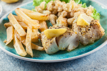 Steamed cod fish with french fries and boiled cauliflower