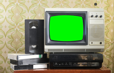 Old silver vintage TV with green screen to add new images to the screen, VCR on wallpaper background.