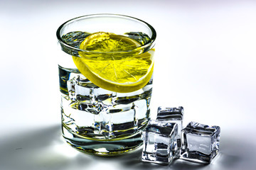 Lemon, ice cubes and water 