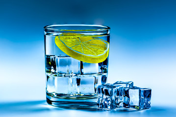 Lemon, ice cubes and water 