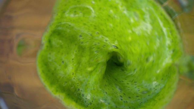 Working blander in the garden, making spinach banana detox smoothie