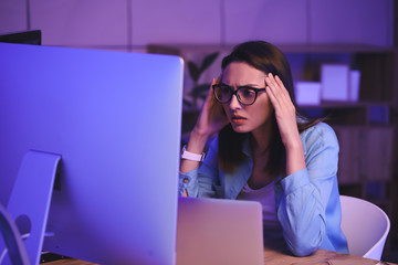 Female programmer working in office at night