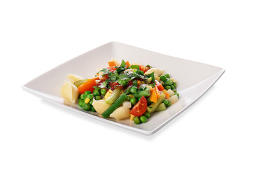 Plate with tasty conchiglie pasta and vegetables on white background
