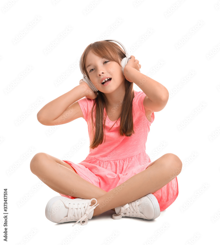 Canvas Prints Little girl listening to music on white background