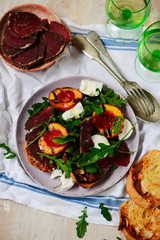 Grilled peaches, goat cheese, and bresaola salad..