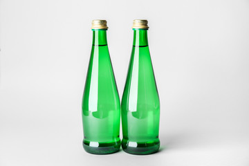 Bottles of clean water on light background