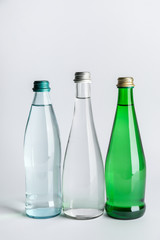 Bottles of clean water on light background