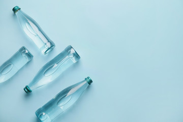 Bottles of clean water on color background