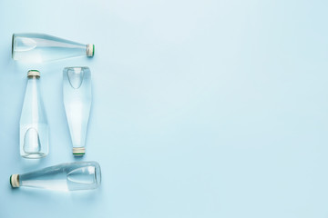 Bottles of clean water on color background