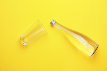 Bottle of clean water and glass on color background