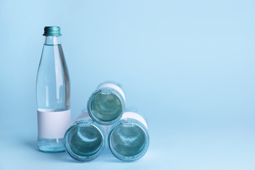 Bottles of clean water on color background