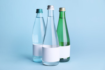 Bottles of clean water on color background