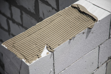 Construction of the walls of the house from foam concrete bricks.