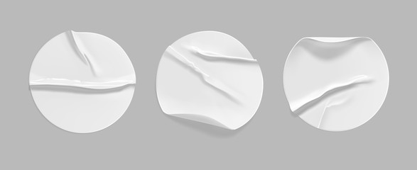 White round crumpled sticker mock up set. Adhesive white paper or plastic sticker label with glued, wrinkled effect on gray background. Blank templates of a label or price tags. 3d realistic vector