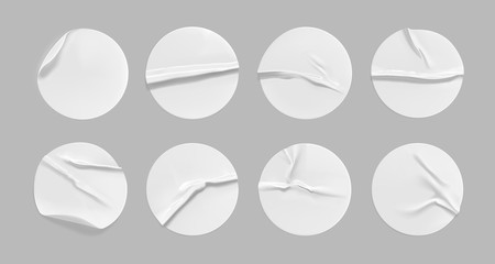 White round crumpled sticker mock up set. Adhesive white paper or plastic sticker label with glued, wrinkled effect on gray background. Blank templates of a label or price tags. 3d realistic vector