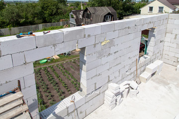 Construction of the walls of the house from foam concrete bricks.