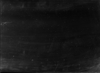 Dust scratches texture. Aged filmstrip. Black distressed surface with white stains noise effect.