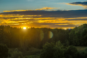 Obraz premium Sunset rural farm meadow horizon view. Cloudy sky.