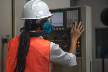 Woman engineering in charge of working duty in dashboard controller of the machine operation in manufactory warehouse