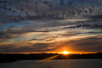 Obraz premium Dramatic and colorful sunset over a forest lake reflected in the water. Blakheide, Beerse, Belgium. High quality photo