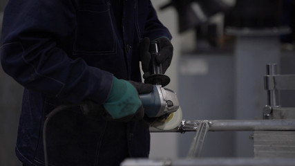 Blacksmith or welder s grinding smooths aluminium, to make the surface smooth. Concept: work,locksmith industry.