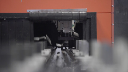 Drilling CNC Machine processes the aluminium profile. Modern tool in heavy industry. High precision manufacture of aluminium parts. Automation of process indoors. Automatic work for ironwork.