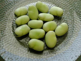 Wild organic lima beans harvesting during summer season. Phaseolus lunatus, commonly known as the lima bean is a legume grown for its edible seeds or beans.