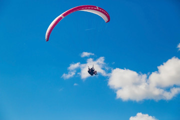 Paragliding in the sky on a sunny day.