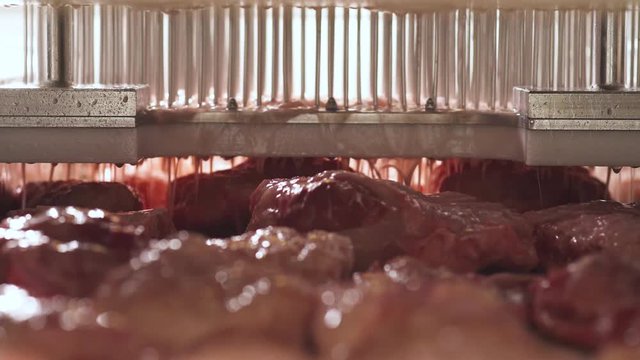 Production of meat products, the process of syringing injection of marinade into pieces of meat.