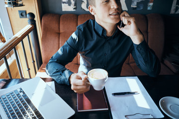 Business man with a cup of coffee in a cafe emotions work in the office stress irritability director