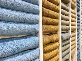 many colorful towels is folding in shelfs at store for Sales .  - 373424799