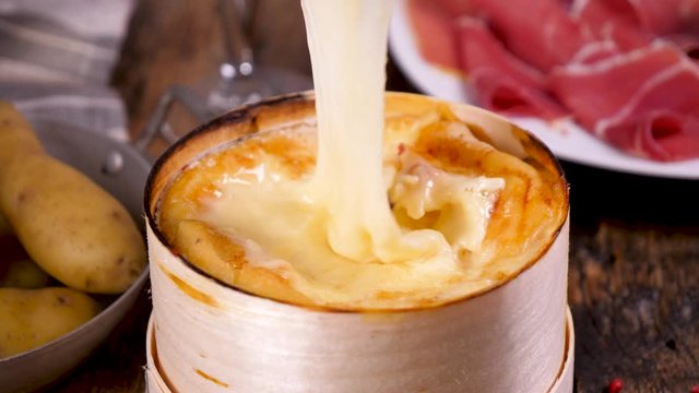 cheese fondue with salami, bacon, potato and wine