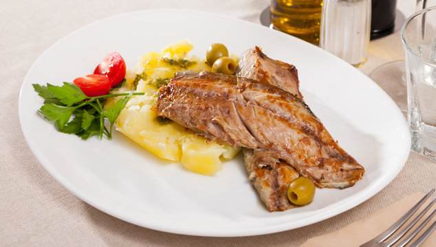Fish dish - roasted scomber fish served with mashed potatoes, cherry tomatoes and parsley