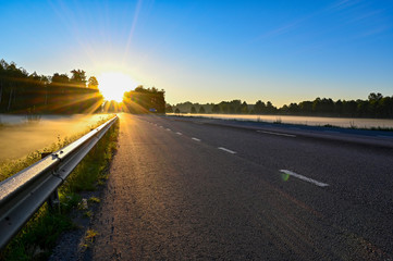 early sunrise over straight road with deminishing perspctive