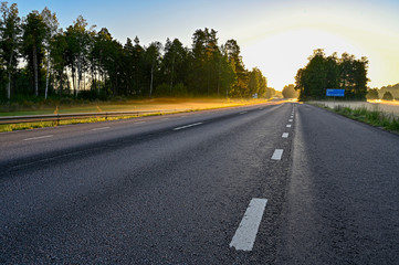 early sunrise over straight road with deminishing perspctive