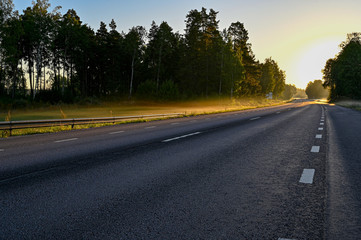 early sunrise over straight road with deminishing perspctive