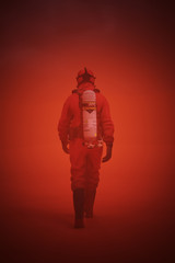 Fototapeta na wymiar Man in a Hazmat Suit Walking in a Post Apocalyptic Dark Sand Storm 3d Illustration 3d render