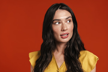 Image of young surprised woman posing and looking aside