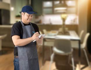 Male Chef assistant taking order and making note