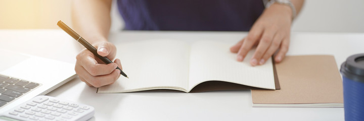 Young woman writing on notebook, Education concept.