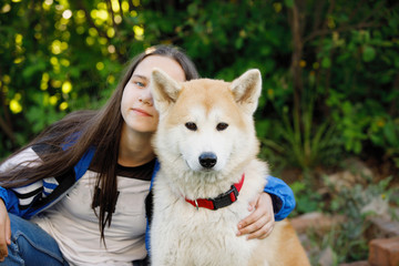 Girl with dog on green grass.